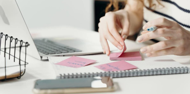 Klare Ziele definieren mit Business-Coaching Hamburg, Frau sortiert Ideen am Schreibtisch